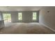 Spacious living area with access to the outdoor patio and abundant natural light at 121 Tanglewood Dr # 8-J, Louisburg, NC 27549
