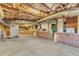 Unfinished basement with exposed brick walls, HVAC system, and ample storage space at 126 Person St, Louisburg, NC 27549