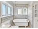 Bathroom with a clawfoot tub, tiled walls, and gold fixtures at 126 Person St, Louisburg, NC 27549