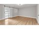 Bright bedroom with hardwood floors, built-in shelving, and barn door at 126 Person St, Louisburg, NC 27549