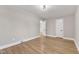 Well-lit bedroom featuring hardwood floors and doors at 126 Person St, Louisburg, NC 27549