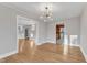 Open dining area showcasing hardwood floors and access to other rooms at 126 Person St, Louisburg, NC 27549