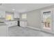 Modern kitchen with white cabinets, granite counters, and stainless steel appliances at 126 Person St, Louisburg, NC 27549