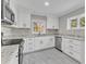 Updated kitchen, featuring white cabinets and granite countertops at 126 Person St, Louisburg, NC 27549
