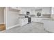 White kitchen cabinets, granite countertops and stainless steel appliances at 126 Person St, Louisburg, NC 27549