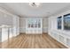 Main bedroom with large window, built-in shelves, and hardwood floors at 126 Person St, Louisburg, NC 27549