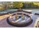 Circular brick patio with fire pit and seating at 126 Person St, Louisburg, NC 27549