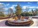 Brick patio with fire pit and seating area at 126 Person St, Louisburg, NC 27549