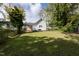 Large grassy backyard with mature trees and a spacious area at 127 E Ridge St, Rocky Mount, NC 27804