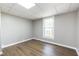 Spacious bedroom with hardwood floors and large window at 127 E Ridge St, Rocky Mount, NC 27804