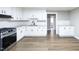 Renovated kitchen with white cabinets, granite countertops, and stainless steel appliances at 127 E Ridge St, Rocky Mount, NC 27804