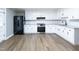 Modern kitchen with white cabinets, stainless steel appliances, and granite countertops at 127 E Ridge St, Rocky Mount, NC 27804