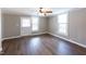 Bright living room with hardwood floors, neutral walls, and large windows at 127 E Ridge St, Rocky Mount, NC 27804