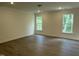 Spacious primary bedroom with hardwood floors and large windows allowing natural light at 129 Stallion Way, Benson, NC 27504