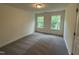 Bright bedroom with two windows and neutral carpet offers a serene living space at 129 Stallion Way, Benson, NC 27504