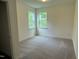 Cozy bedroom featuring plush carpet and sun-filled windows for a bright and airy feel at 129 Stallion Way, Benson, NC 27504