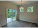 Bright dining area with sliding glass door and modern lighting; views of the outdoors at 129 Stallion Way, Benson, NC 27504
