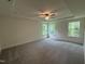 Spacious main bedroom with a tray ceiling and a ceiling fan with natural light from three windows at 129 Stallion Way, Benson, NC 27504