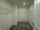 Ample walk-in closet featuring shelving, and neutral carpet at 129 Stallion Way, Benson, NC 27504