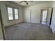 Bedroom with carpet floors, double windows, a ceiling fan and a doorway to another room at 1301 Branch St, Rocky Mount, NC 27801