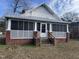 Brick home with screened porch and steps leading to the front door at 1301 Branch St, Rocky Mount, NC 27801