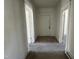 A hallway with carpet floors and white walls, with doorways to other rooms at 1301 Branch St, Rocky Mount, NC 27801