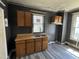 A kitchen area featuring wood cabinets, double bowl sink, and modern plank flooring at 1301 Branch St, Rocky Mount, NC 27801