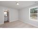 Bedroom with carpeted floor and view of wooded area at 144 Weavers Grove Dr, Chapel Hill, NC 27514