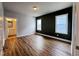 Spacious bedroom with hardwood floors and an accent wall at 144 Weavers Grove Dr, Chapel Hill, NC 27514