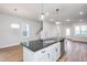 Modern kitchen with white cabinets, granite countertops, and stainless steel appliances at 144 Weavers Grove Dr, Chapel Hill, NC 27514
