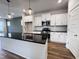 Modern kitchen with white cabinets, granite island, and stainless steel appliances at 144 Weavers Grove Dr # 121, Chapel Hill, NC 27514