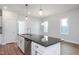 Modern kitchen with white cabinets, granite countertops, and stainless steel appliances at 144 Weavers Grove Dr, Chapel Hill, NC 27514