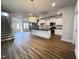 Open concept kitchen and living area with island and hardwood floors at 144 Weavers Grove Dr, Chapel Hill, NC 27514