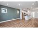 Open concept kitchen and living area with island, stainless steel appliances, and hardwood floors at 144 Weavers Grove Dr, Chapel Hill, NC 27514