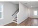 Modern staircase with hardwood floors and white railing at 144 Weavers Grove Dr, Chapel Hill, NC 27514