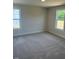 Bedroom showing carpet flooring and natural light through two windows at 145 Surles Landing Way, Benson, NC 27504