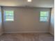 Bedroom featuring carpet and two windows providing ample natural light at 145 Surles Landing Way, Benson, NC 27504