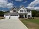 Charming two-story home featuring a three-car garage and beautiful traditional architecture at 145 Surles Landing Way, Benson, NC 27504