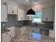Kitchen with stainless appliances, white cabinets, and gray backsplash at 145 Surles Landing Way, Benson, NC 27504