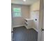 Practical laundry room with shelving and patterned vinyl flooring at 145 Surles Landing Way, Benson, NC 27504