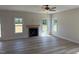 Living room with hardwood floors, fireplace, and natural light from windows at 145 Surles Landing Way, Benson, NC 27504