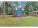 Cute brick ranch home with blue accents and a grassy yard at 1558 Harper St, Rocky Mount, NC 27801