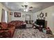 Living area featuring two sofas, a TV, and a ceiling fan at 1558 Harper St, Rocky Mount, NC 27801