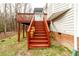 Red wooden stairs leading to deck at 1610 Rogers Pointe Ln, Creedmoor, NC 27522