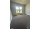 Well-lit bedroom with carpet and a window overlooking the yard at 1684 Pecan Drive # 43, Nashville, NC 27856