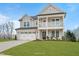 Two-story home with gray siding, white trim, and a two-car garage at 1783 Ballard Rd # Apex Georgian, Fuquay Varina, NC 27526