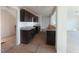 Kitchen area featuring dark cabinets, light countertops, and an open layout at 204 S Beaumont Ave, Burlington, NC 27217