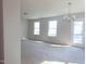 Bright living room with a modern chandelier and a glass door leading to the backyard at 204 S Beaumont Ave, Burlington, NC 27217