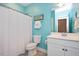 Charming bathroom with teal walls and white vanity at 228 Silverhawk Ln, Durham, NC 27703