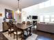 Open concept dining area with a large wooden table and views into the living room at 2508 Rambling Creek Rd, Apex, NC 27523